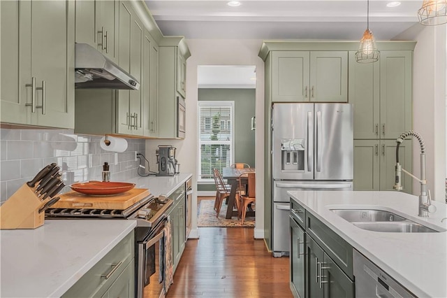109 Overbrook Dr, Cranberry Twp, PA 16066 - kitchen with under cabinet range hood, green cabinets, stainless steel appliances, dark wood-style floors, and pendant lighting