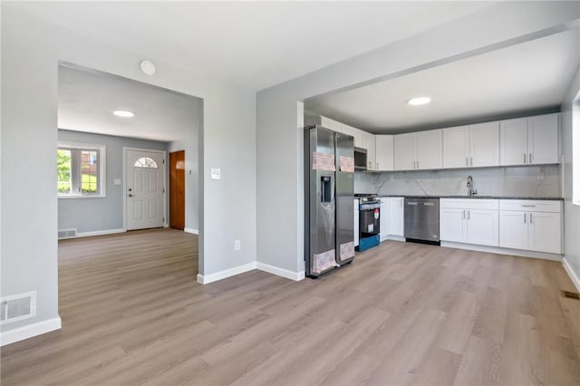 1625 Loretta Dr, Penn Hills, PA 15235 - kitchen with stainless steel appliances, light wood-style floors, white cabinets, backsplash, and recessed lighting