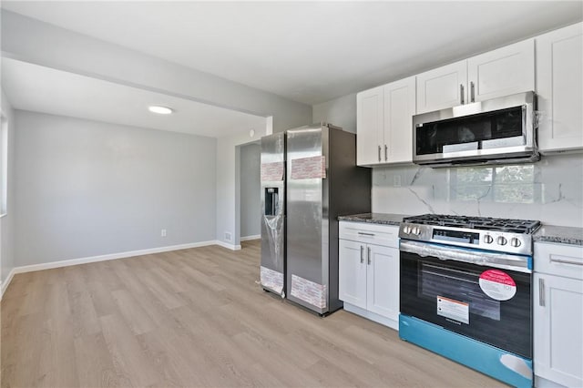 1625 Loretta Dr, Penn Hills, PA 15235 - kitchen featuring stainless steel appliances, light wood-style flooring, white cabinetry, and dark stone counters