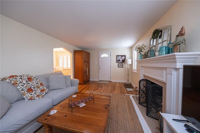 4800 W Brierly Dr, West Mifflin, PA 15122 - living room with wood finished floors, a fireplace, and arched walkways