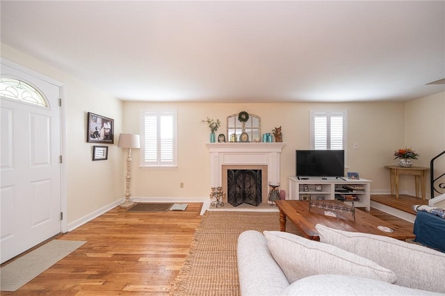 4800 W Brierly Dr, West Mifflin, PA 15122 - living room with a fireplace with raised hearth, healthy amount of natural light, and light wood-style flooring
