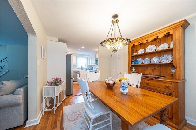4800 W Brierly Dr, West Mifflin, PA 15122 - dining area featuring light wood finished floors and arched walkways