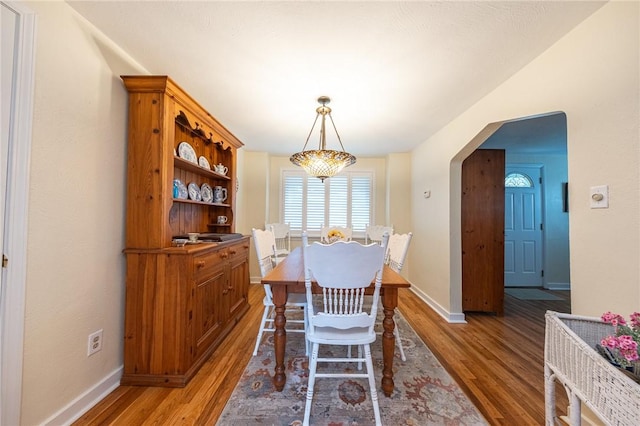 4800 W Brierly Dr, West Mifflin, PA 15122 - dining space featuring light wood-style flooring and arched walkways