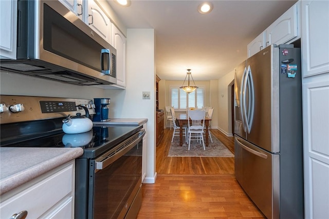 4800 W Brierly Dr, West Mifflin, PA 15122 - kitchen featuring appliances with stainless steel finishes, light wood finished floors, white cabinetry, light countertops, and recessed lighting