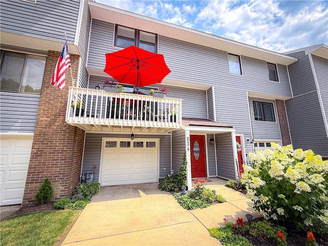 534 Hunters Path Rd, South Fayette, PA 15017 - view of property featuring driveway, an attached garage, a balcony, and brick siding
