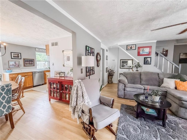 534 Hunters Path Rd, South Fayette, PA 15017 - living area with a textured ceiling, light wood finished floors, and stairs