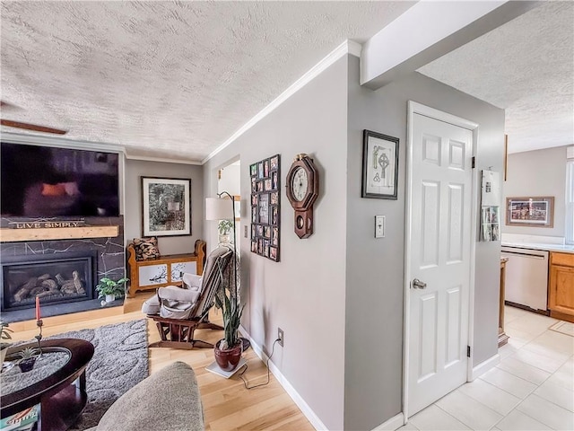 534 Hunters Path Rd, South Fayette, PA 15017 - living room featuring a textured ceiling, a fireplace with raised hearth, and ornamental molding