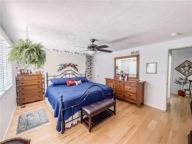 534 Hunters Path Rd, South Fayette, PA 15017 - bedroom with light wood-style floors, a textured ceiling, and a ceiling fan