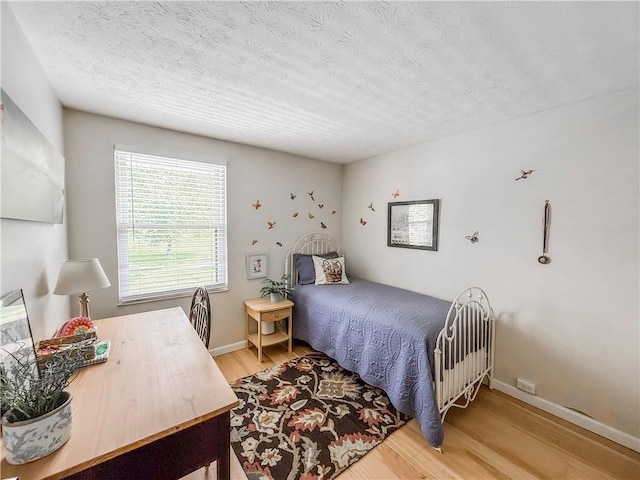 534 Hunters Path Rd, South Fayette, PA 15017 - bedroom with wood finished floors and a textured ceiling