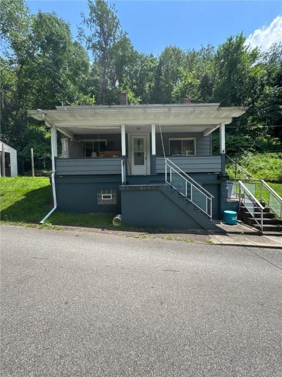 6036 Sawyer St, Lawrenceville, PA 15201 - view of front of property with stairway, a chimney, view of scattered trees, and covered porch