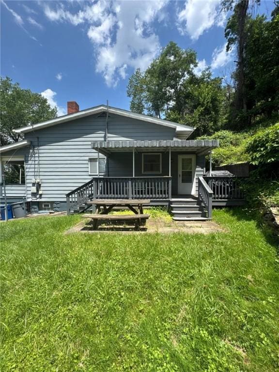 6036 Sawyer St, Lawrenceville, PA 15201 - back of house with a wooden deck, a chimney, and a yard