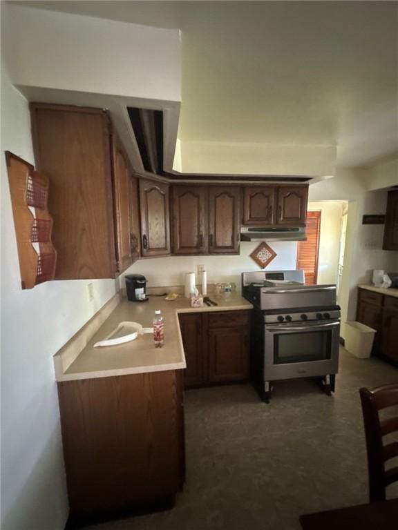 6036 Sawyer St, Lawrenceville, PA 15201 - kitchen featuring stainless steel stove, under cabinet range hood, light countertops, and dark brown cabinetry