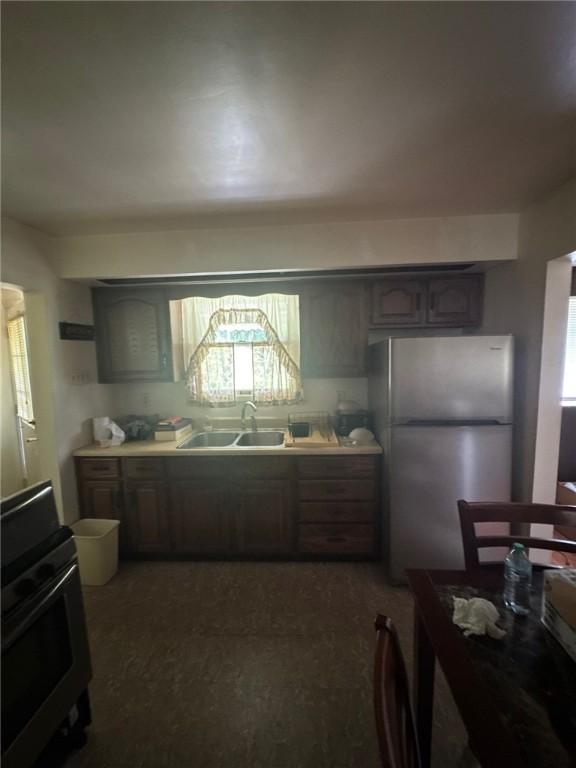 6036 Sawyer St, Lawrenceville, PA 15201 - kitchen with freestanding refrigerator, range, light countertops, and dark carpet