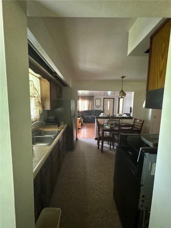 6036 Sawyer St, Lawrenceville, PA 15201 - kitchen featuring freestanding refrigerator and hanging light fixtures