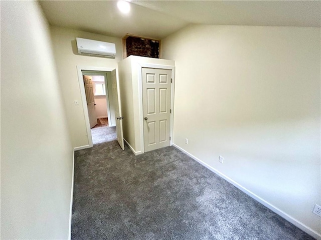 718 Breakneck Rd, Bullskin Twp, PA 15425 - empty room featuring a wall unit AC, dark carpet, and lofted ceiling