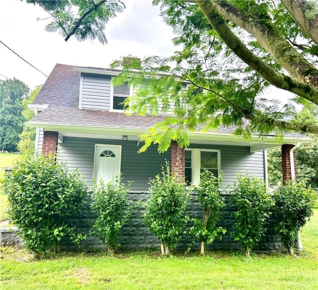 718 Breakneck Rd, Bullskin Twp, PA 15425 - view of front facade featuring covered porch and a front lawn