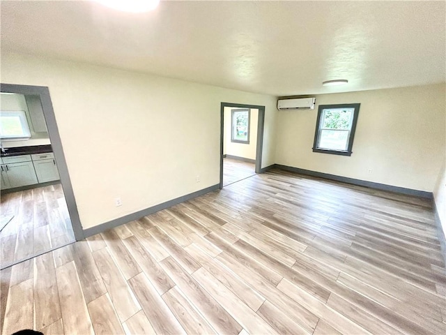 718 Breakneck Rd, Bullskin Twp, PA 15425 - unfurnished room featuring an AC wall unit and light wood-style flooring