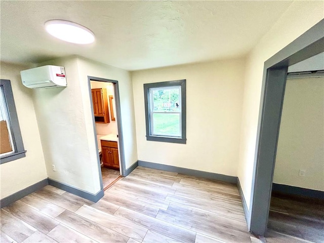 718 Breakneck Rd, Bullskin Twp, PA 15425 - unfurnished bedroom with a wall mounted air conditioner and light wood finished floors
