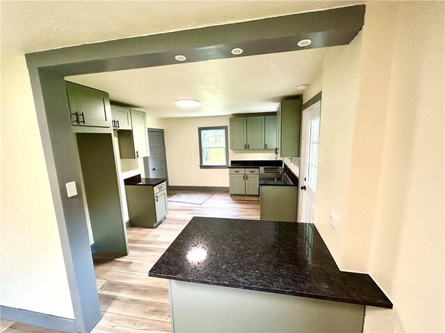718 Breakneck Rd, Bullskin Twp, PA 15425 - kitchen featuring light wood-style flooring, dark stone countertops, and a peninsula