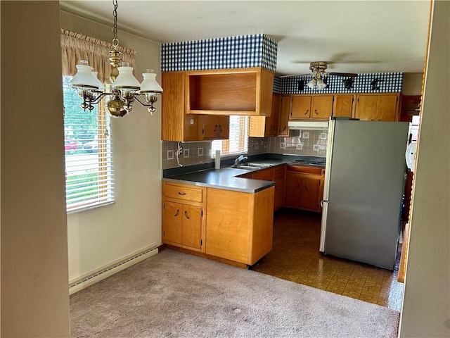 130 Overlook Dr, Brighton Twp, PA 15009 - kitchen with freestanding refrigerator, baseboard heating, a peninsula, brown cabinets, and a chandelier