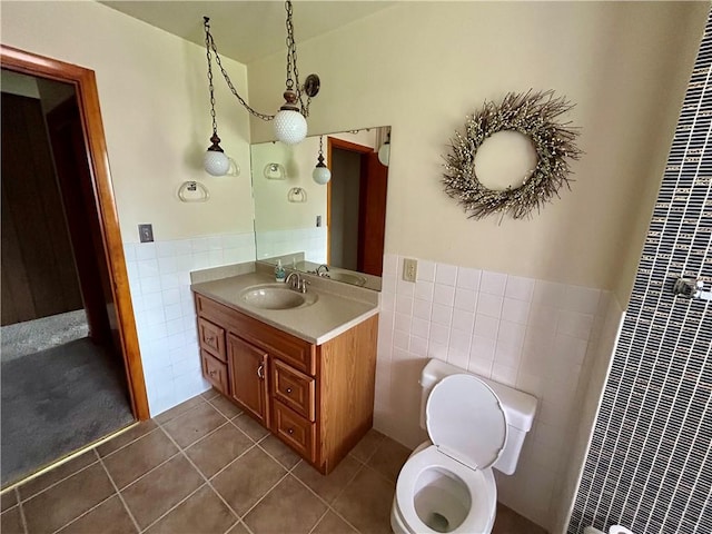 130 Overlook Dr, Brighton Twp, PA 15009 - bathroom with tile walls, tile patterned floors, vanity, and a wainscoted wall