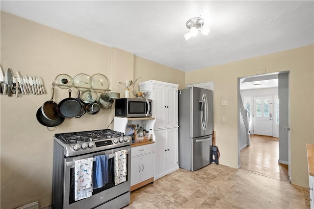 2102 Vodeli St, Beechview, PA 15216 - kitchen with appliances with stainless steel finishes and white cabinets