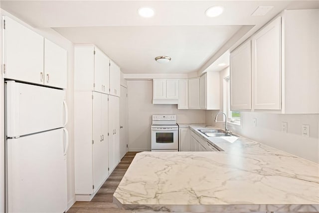 1837 Stoystown, Somerset Twp, PA 15541 - kitchen featuring white appliances, white cabinetry, wood finished floors, a peninsula, and recessed lighting