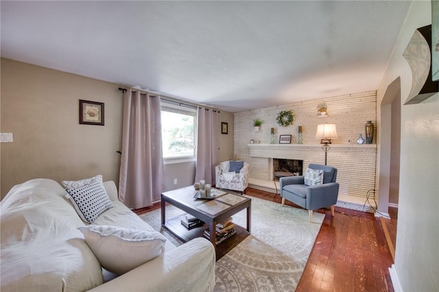 5215 Caste Dr, Whitehall, PA 15236 - living area with hardwood / wood-style floors, a brick fireplace, and brick wall