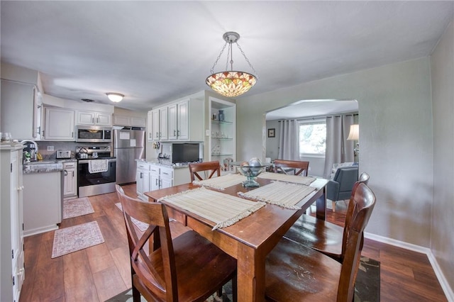 5215 Caste Dr, Whitehall, PA 15236 - dining area with dark wood finished floors and arched walkways