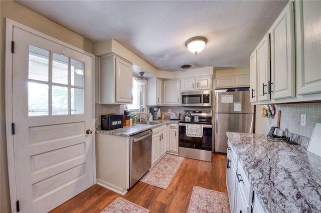 5215 Caste Dr, Whitehall, PA 15236 - kitchen with stainless steel appliances, healthy amount of natural light, backsplash, and wood finished floors