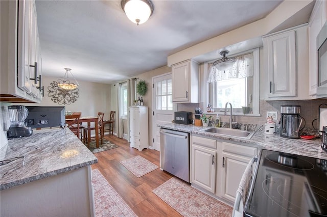 5215 Caste Dr, Whitehall, PA 15236 - kitchen with dishwasher, range with electric cooktop, white cabinets, and backsplash