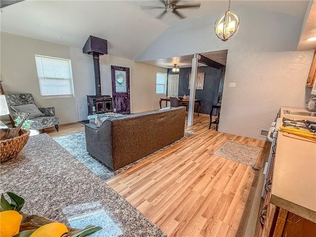 808 Thompson Run Rd, Springdale Twp, PA 15049 - living room featuring light wood-type flooring, a ceiling fan, vaulted ceiling, and a wood stove