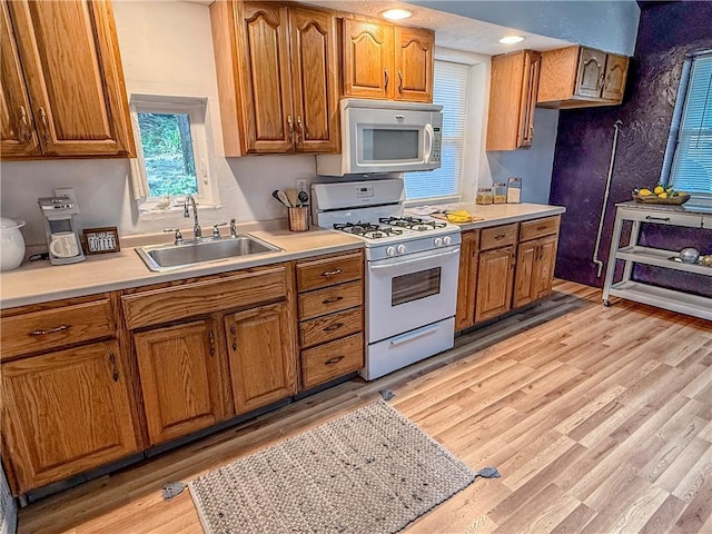 808 Thompson Run Rd, Springdale Twp, PA 15049 - kitchen featuring white appliances, brown cabinetry, light countertops, and light wood-type flooring