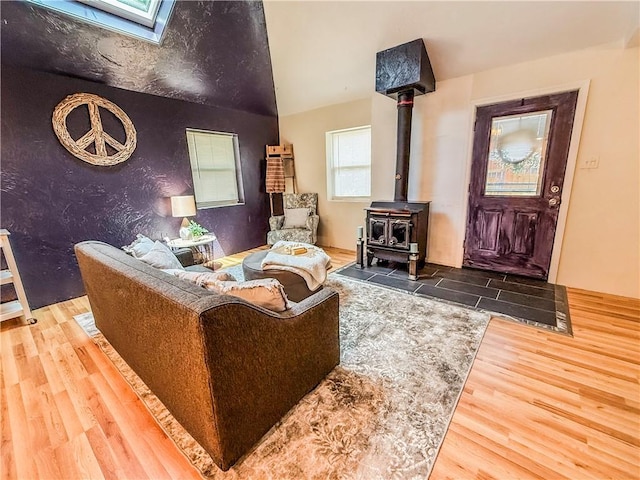 808 Thompson Run Rd, Springdale Twp, PA 15049 - living room with wood finished floors, a wood stove, and a skylight