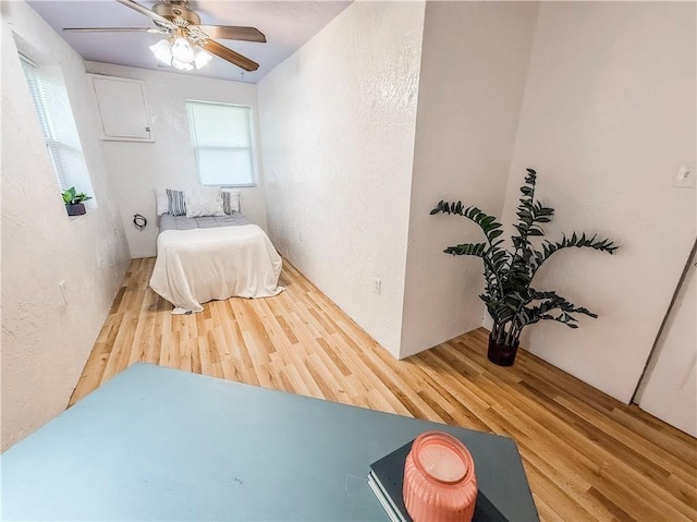 808 Thompson Run Rd, Springdale Twp, PA 15049 - bedroom featuring wood finished floors, a textured wall, and ceiling fan
