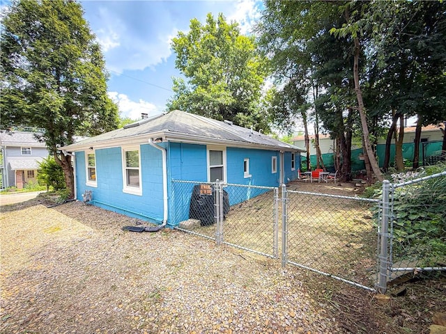 808 Thompson Run Rd, Springdale Twp, PA 15049 - back of house with concrete block siding, a gate, and a shingled roof