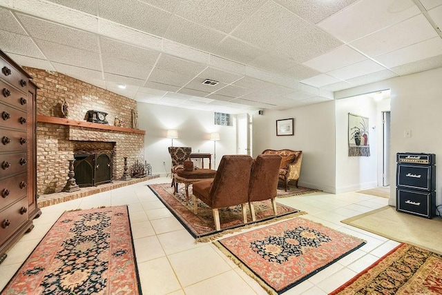 1115 Valleyview Dr, Cecil, PA 15055 - tiled living area featuring a paneled ceiling and a brick fireplace
