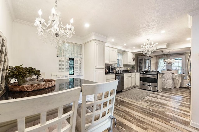 1115 Valleyview Dr, Cecil, PA 15055 - kitchen featuring a chandelier, appliances with stainless steel finishes, crown molding, light wood finished floors, and recessed lighting