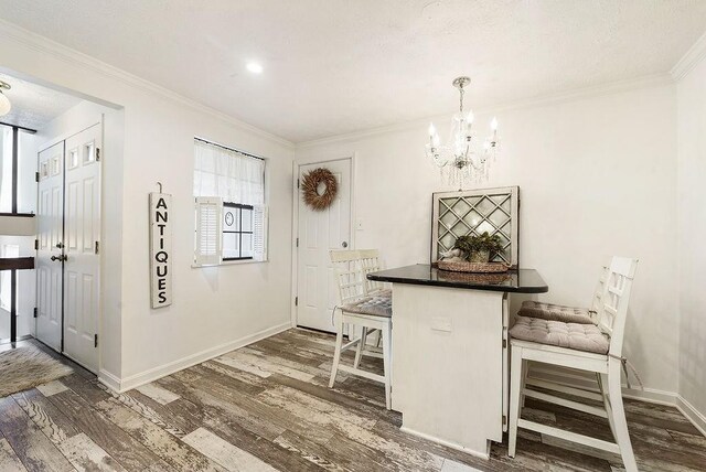 1115 Valleyview Dr, Cecil, PA 15055 - dining area with wood finished floors, a chandelier, and crown molding
