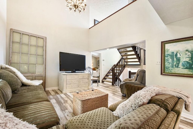 1115 Valleyview Dr, Cecil, PA 15055 - living area with stairs, a chandelier, wood finished floors, and a high ceiling