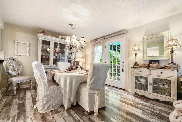 1115 Valleyview Dr, Cecil, PA 15055 - dining area with a chandelier, wood finished floors, and a textured ceiling