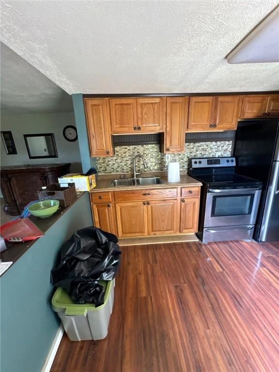 5015 Walnut St, Versailles Boro, PA 15132 - kitchen with stainless steel range with electric cooktop, brown cabinets, dark wood-style floors, and a textured ceiling