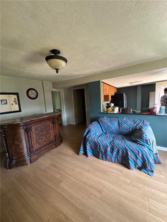 5015 Walnut St, Versailles Boro, PA 15132 - bedroom featuring a textured ceiling, wood finished floors, and freestanding refrigerator