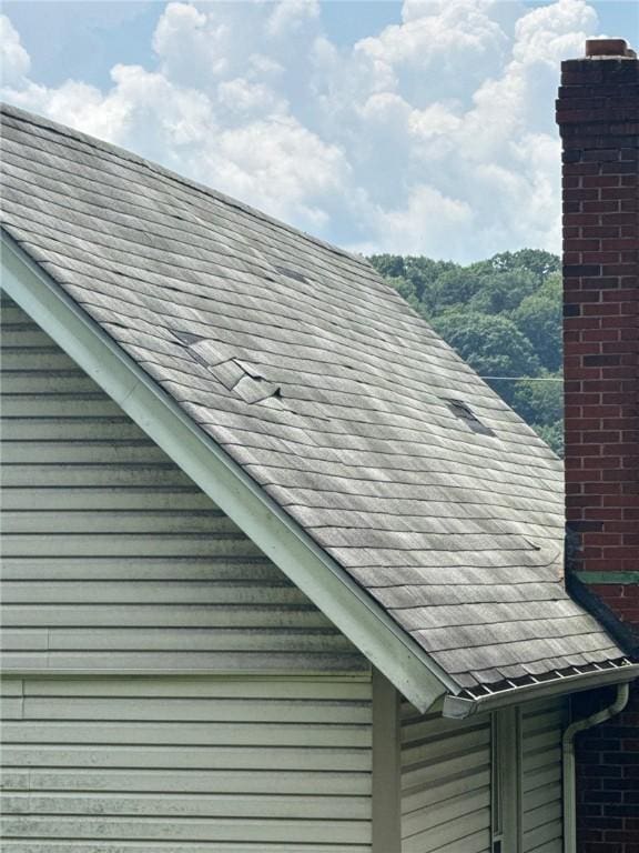 5015 Walnut St, Versailles Boro, PA 15132 - exterior view of gutters, a chimney, a shingled roof, and a downspout