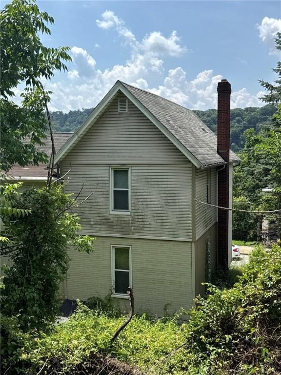 5015 Walnut St, Versailles Boro, PA 15132 - view of side of property featuring a chimney and a shingled roof