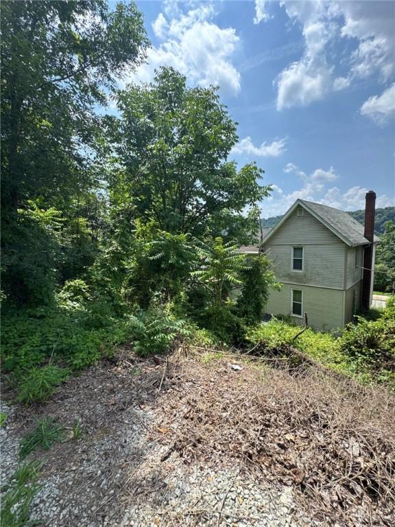 5015 Walnut St, Versailles Boro, PA 15132 - view of property exterior with a chimney