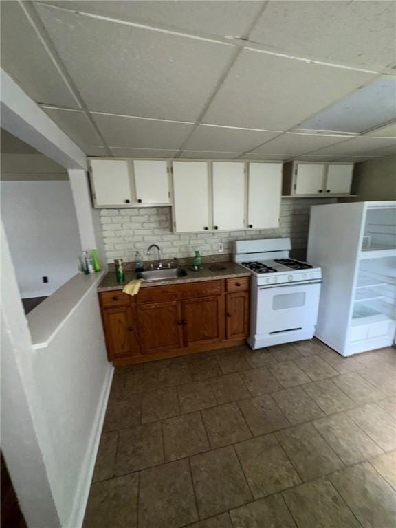 5015 Walnut St, Versailles Boro, PA 15132 - kitchen featuring white appliances, a drop ceiling, white cabinetry, tasteful backsplash, and light countertops