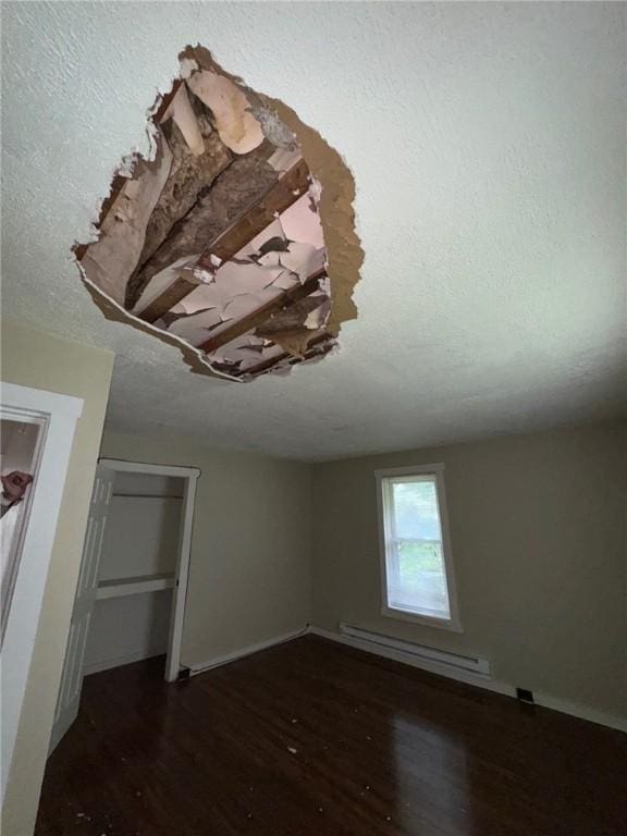5015 Walnut St, Versailles Boro, PA 15132 - detailed view of a baseboard heating unit, wood finished floors, and a textured ceiling