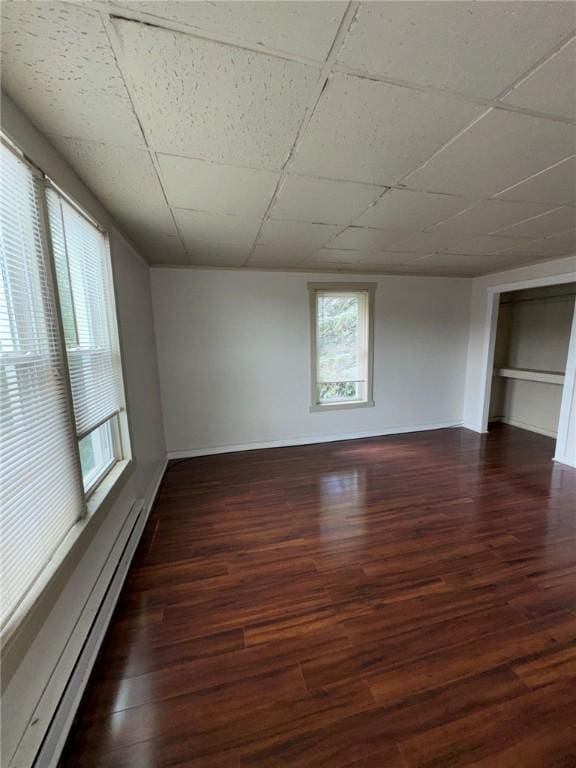 5015 Walnut St, Versailles Boro, PA 15132 - unfurnished room with baseboard heating, dark wood-style floors, and a drop ceiling