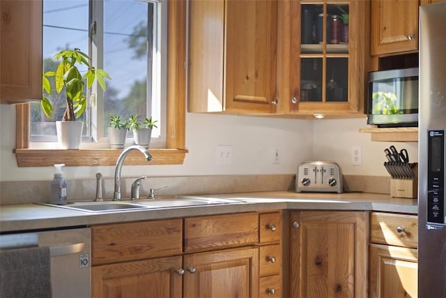 108 Republic Ave, Indiana Twp, PA 15051 - kitchen featuring appliances with stainless steel finishes, glass insert cabinets, brown cabinetry, and light countertops